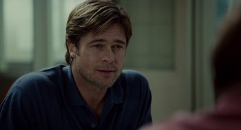 Movie still from “Moneyball” (2011), directed by Bennett Miller – A person sitting in front of a window; Close Up shot, Over the shoulder angle