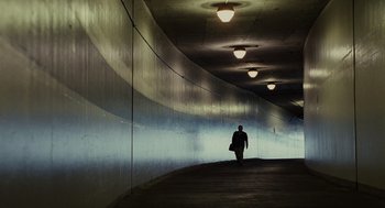 Movie still from “Moneyball” (2011), directed by Bennett Miller – A man walking down a hallway in a tunnel; Extreme Wide shot, Low angle