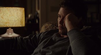 Movie still from “Moneyball” (2011), directed by Bennett Miller – A man sitting on a couch with his head resting on his hand; Close Up shot, Over the shoulder angle
