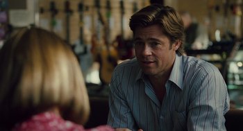 Movie still from “Moneyball” (2011), directed by Bennett Miller – A man sitting in front of a woman at a table; Close Up shot, Over the shoulder angle