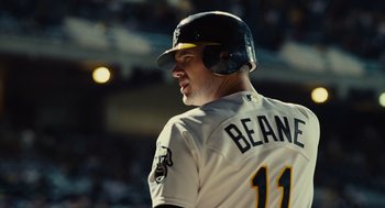 Movie still from “Moneyball” (2011), directed by Bennett Miller – A baseball player in a white uniform and a helmet; Close Up shot, Over the shoulder angle
