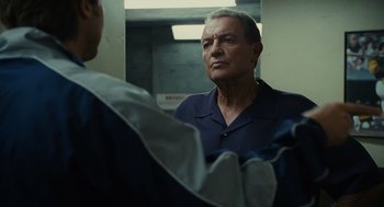 Movie still from “Moneyball” (2011), directed by Bennett Miller – A man standing in front of a mirror talking to another man; Close Up shot, Low angle