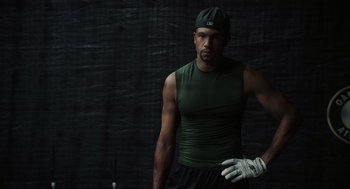 Movie still from “Moneyball” (2011), directed by Bennett Miller – A man in a green shirt and white gloves; Medium shot, Low angle