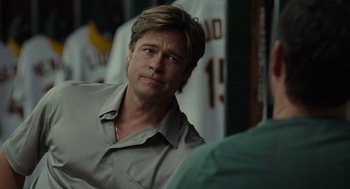 Movie still from “Moneyball” (2011), directed by Bennett Miller – A man with a long hair is looking at the camera; Close Up shot, Over the shoulder angle