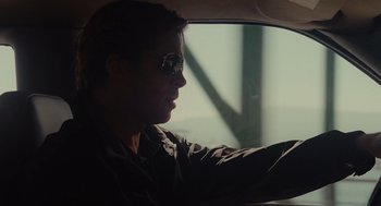 Movie still from “Moneyball” (2011), directed by Bennett Miller – A man driving in a car wearing sunglasses; Close Up shot, Over the shoulder angle