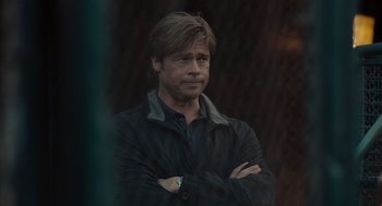 Movie still from “Moneyball” (2011), directed by Bennett Miller – A person with his arms crossed; Close Up shot, Over the shoulder angle