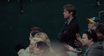 Movie still from “Moneyball” (2011), directed by Bennett Miller – A man standing in front of a group of people; Medium shot, Over the shoulder angle