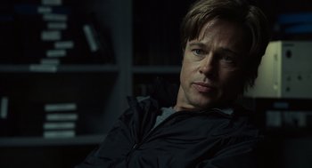 Movie still from “Moneyball” (2011), directed by Bennett Miller – A person sitting in a chair; Close Up shot, Over the shoulder angle