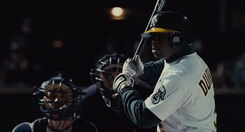 Movie still from “Moneyball” (2011), directed by Bennett Miller – A baseball player holding a baseball bat in a dugout; Close Up shot, Over the shoulder angle