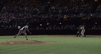 Movie still from “Moneyball” (2011), directed by Bennett Miller – A baseball player throwing a ball at a baseball game; Extreme Wide shot, High angle