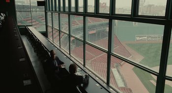 Movie still from “Moneyball” (2011), directed by Bennett Miller – Two men sitting in a stadium watching a baseball game; Extreme Wide shot, High angle