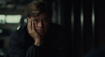 Movie still from “Moneyball” (2011), directed by Bennett Miller – A person with his hand on his face; Close Up shot, Over the shoulder angle