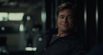 Movie still from “Moneyball” (2011), directed by Bennett Miller – A person sitting in a room; Close Up shot, Over the shoulder angle