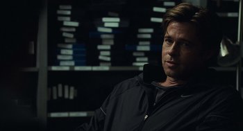 Movie still from “Moneyball” (2011), directed by Bennett Miller – A person wearing a black jacket; Close Up shot, Over the shoulder angle