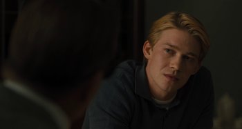 Movie still from “Operation Finale” (2018), directed by Chris Weitz – A man sitting in front of a mirror looking at the camera; Close Up shot, Over the shoulder angle