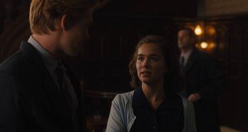 Movie still from “Operation Finale” (2018), directed by Chris Weitz – A woman is talking to a man in a dark room; Medium shot, Over the shoulder angle