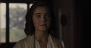Movie still from “Operation Finale” (2018), directed by Chris Weitz – A young woman in a white shirt and jacket; Close Up shot, Over the shoulder angle