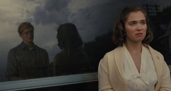 Movie still from “Operation Finale” (2018), directed by Chris Weitz – A woman standing in front of a train window; Close Up shot, Over the shoulder angle