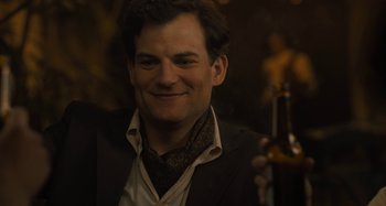 Movie still from “Operation Finale” (2018), directed by Chris Weitz – A person wearing a suit and tie; Close Up shot, Over the shoulder angle