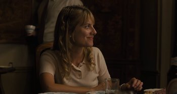 Movie still from “Operation Finale” (2018), directed by Chris Weitz – A woman sitting at a table with a glass of water; Close Up shot, Over the shoulder angle