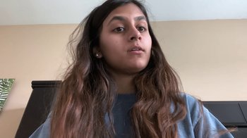 Movie still from “Operation Varsity Blues” (2021), directed by Chris Smith – A woman with long brown hair looking at the camera; Close Up shot, High angle