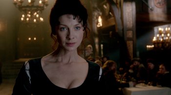 Movie still from “Outlander” (2014), created by Ronald D. Moore – A woman with blue eyes in a black dress; Close Up shot, Over the shoulder angle