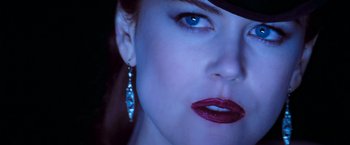 Movie still from “Moulin Rouge!” (2001), directed by Baz Luhrmann – A woman's blue eyes and red lips; Close Up shot, Over the shoulder angle