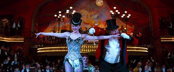 Movie still from “Moulin Rouge!” (2001), directed by Baz Luhrmann – A man and a woman performing a dance in a circus; Medium shot, Low angle