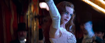 Movie still from “Moulin Rouge!” (2001), directed by Baz Luhrmann – A woman in a white dress and white gloves; Close Up shot, Low angle