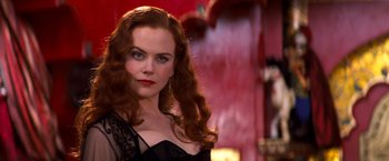 Movie still from “Moulin Rouge!” (2001), directed by Baz Luhrmann – A woman with long red hair wearing a black dress; Close Up shot, Over the shoulder angle