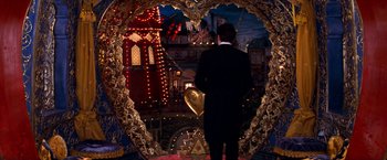 Movie still from “Moulin Rouge!” (2001), directed by Baz Luhrmann – A man standing in a heart shaped mirror; Wide shot, Over the shoulder angle
