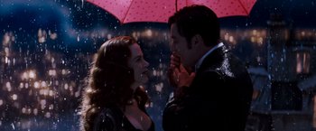 Movie still from “Moulin Rouge!” (2001), directed by Baz Luhrmann – A man and a woman standing under an umbrella in the rain; Medium shot, Low angle