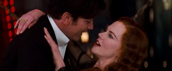 Movie still from “Moulin Rouge!” (2001), directed by Baz Luhrmann – A man and a woman are kissing each other; Close Up shot, Low angle