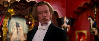 Movie still from “Moulin Rouge!” (2001), directed by Baz Luhrmann – A person wearing a suit and bow tie; Close Up shot, Low angle