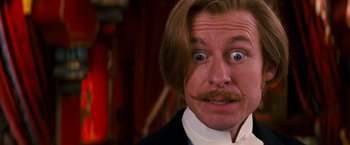 Movie still from “Moulin Rouge!” (2001), directed by Baz Luhrmann – A person wearing a suit and tie; Close Up shot, Over the shoulder angle