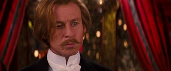 Movie still from “Moulin Rouge!” (2001), directed by Baz Luhrmann – A person wearing a suit and tie; Close Up shot, Over the shoulder angle