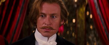 Movie still from “Moulin Rouge!” (2001), directed by Baz Luhrmann – A person wearing a suit and tie; Close Up shot, Over the shoulder angle