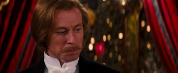 Movie still from “Moulin Rouge!” (2001), directed by Baz Luhrmann – A person wearing a suit and a bow tie; Close Up shot, Over the shoulder angle