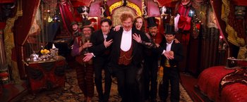 Movie still from “Moulin Rouge!” (2001), directed by Baz Luhrmann – A group of men and women dressed up in costumes; Wide shot, Low angle