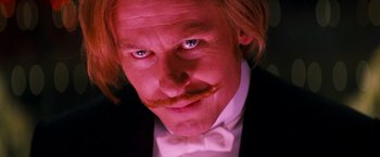 Movie still from “Moulin Rouge!” (2001), directed by Baz Luhrmann – A person wearing a suit and bow tie; Close Up shot, Low angle