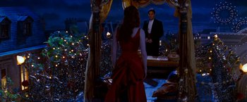 Movie still from “Moulin Rouge!” (2001), directed by Baz Luhrmann – A man and a woman standing in front of a tent; Wide shot, High angle