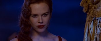 Movie still from “Moulin Rouge!” (2001), directed by Baz Luhrmann – A person with red lipstick; Close Up shot, Over the shoulder angle