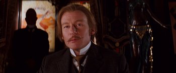 Movie still from “Moulin Rouge!” (2001), directed by Baz Luhrmann – A person wearing a suit and tie; Close Up shot, Low angle