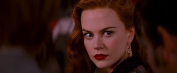 Movie still from “Moulin Rouge!” (2001), directed by Baz Luhrmann – A person with red hair and blue eyes; Close Up shot, Over the shoulder angle