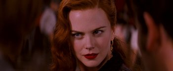 Movie still from “Moulin Rouge!” (2001), directed by Baz Luhrmann – A person with long red hair; Close Up shot, Over the shoulder angle