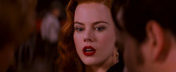 Movie still from “Moulin Rouge!” (2001), directed by Baz Luhrmann – A person with red lipstick on their lips; Close Up shot, Over the shoulder angle