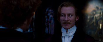 Movie still from “Moulin Rouge!” (2001), directed by Baz Luhrmann – A person wearing a suit and tie; Close Up shot, Over the shoulder angle