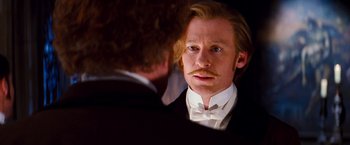 Movie still from “Moulin Rouge!” (2001), directed by Baz Luhrmann – A person wearing a suit and a bow tie; Close Up shot, Over the shoulder angle