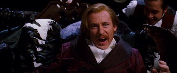 Movie still from “Moulin Rouge!” (2001), directed by Baz Luhrmann – A person with a beard and a mustache; Close Up shot, Low angle