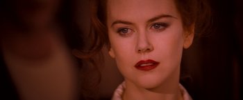 Movie still from “Moulin Rouge!” (2001), directed by Baz Luhrmann – A person with red lipstick on her lips; Close Up shot, Over the shoulder angle